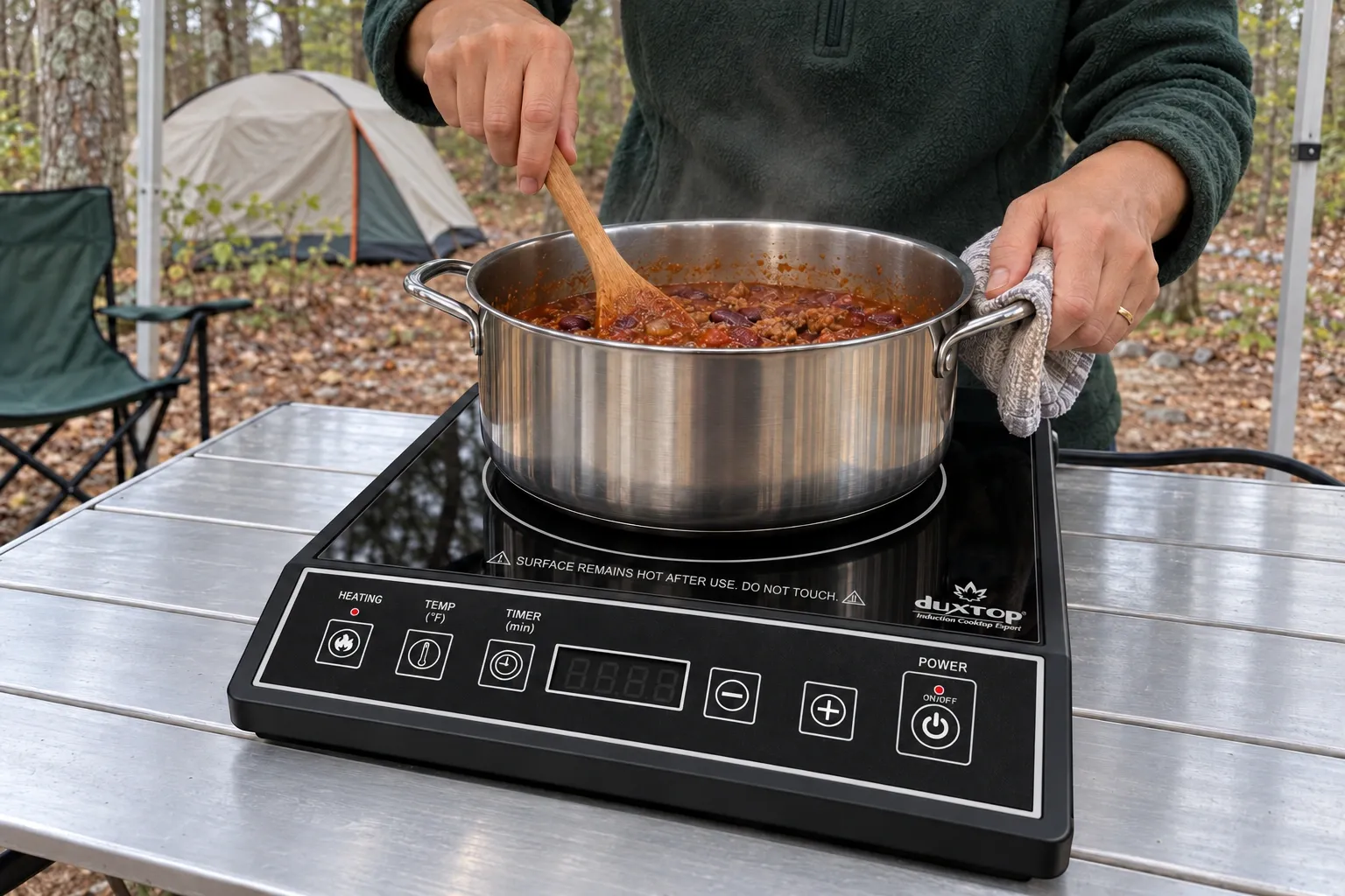 A pot of chili cooking on a Duxtop 9100MC portable burner at a campsite.