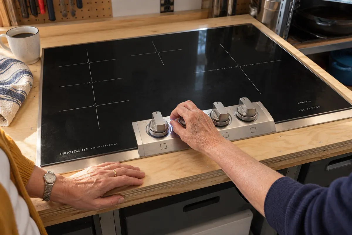 Her mother's hands turning a backlit knob on a Frigidaire Professional PCCI3080AF