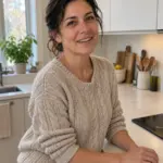 Sarah Simon in her kitchen next to her induction cooktop